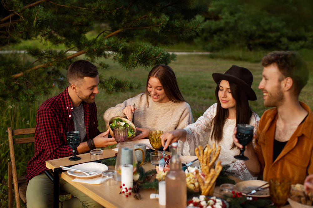 Campers enjoying a delicious dinner around the campfire
